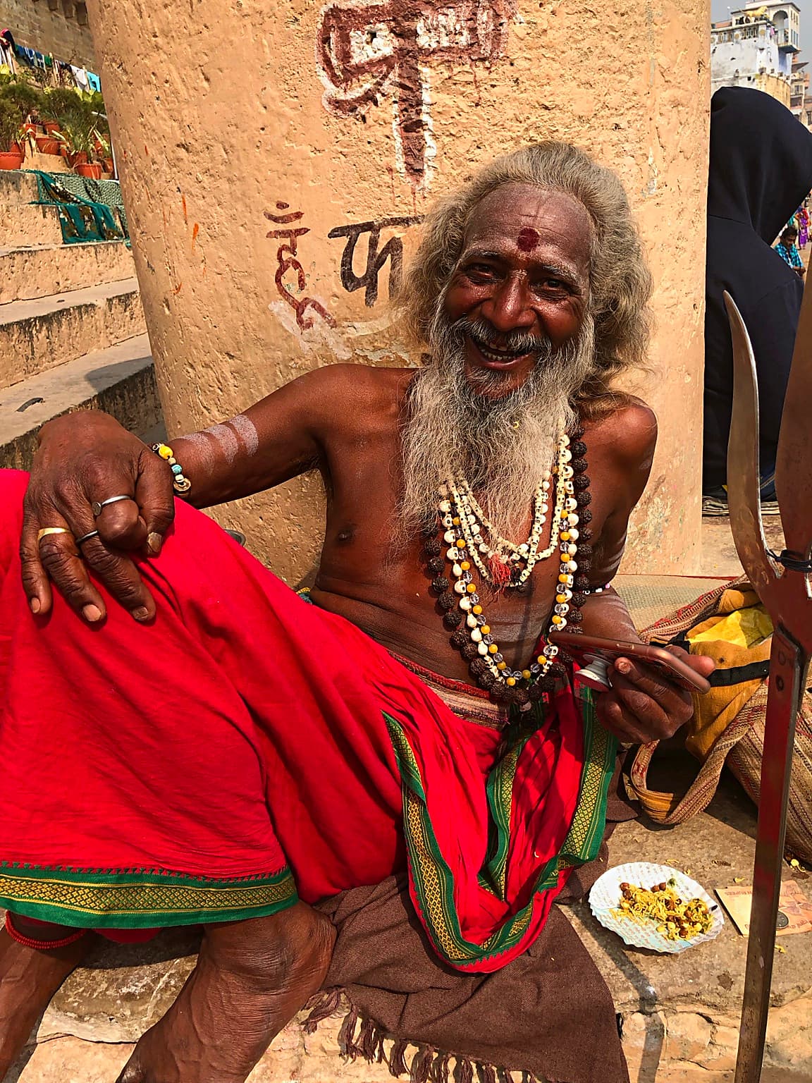 The sadhu smiling openly at the photographer.